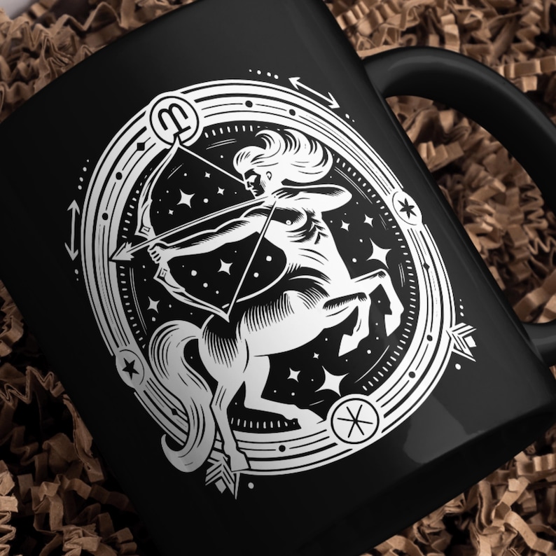May include: Black ceramic mug with a white illustration of a centaur holding a bow and arrow. The illustration is surrounded by a circle with stars and the astrological symbol for Sagittarius.