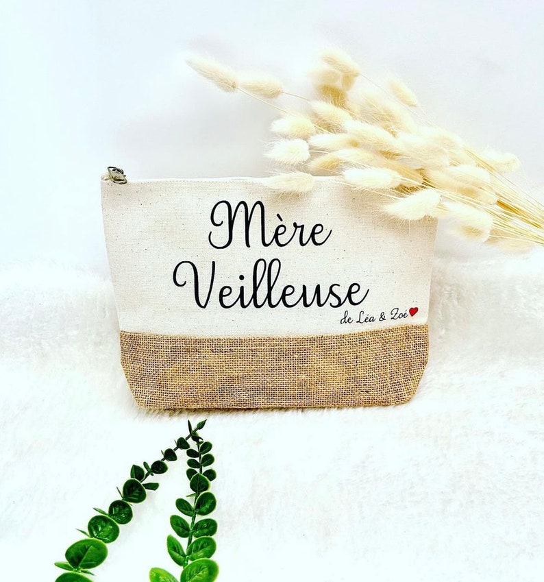 Op de afbeelding: Een witte canvas en jute toilettas met de tekst "M&egrave;re Veilleuse de L&eacute;a & Zo&eacute;" en een rood hart.