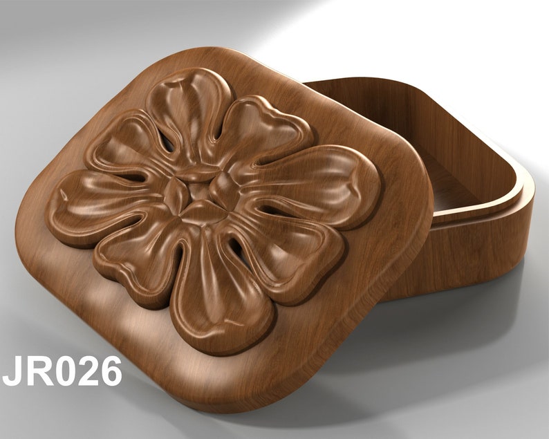 May include: A wooden box with a carved flower design on the lid. The lid is open, revealing the empty interior of the box. The box is labeled "JR026".