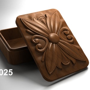 May include: A wooden box with a carved floral design on the lid. The lid is open and the inside of the box is empty. The box is labeled "JR025".