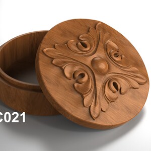 May include: A wooden box with a carved floral design on the lid. The box is open and the inside is visible. The box is labeled "JC021".