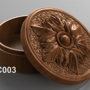 May include: A wooden box with a carved floral design on the lid. The box is open and the inside is visible. The box is labeled "JC003".