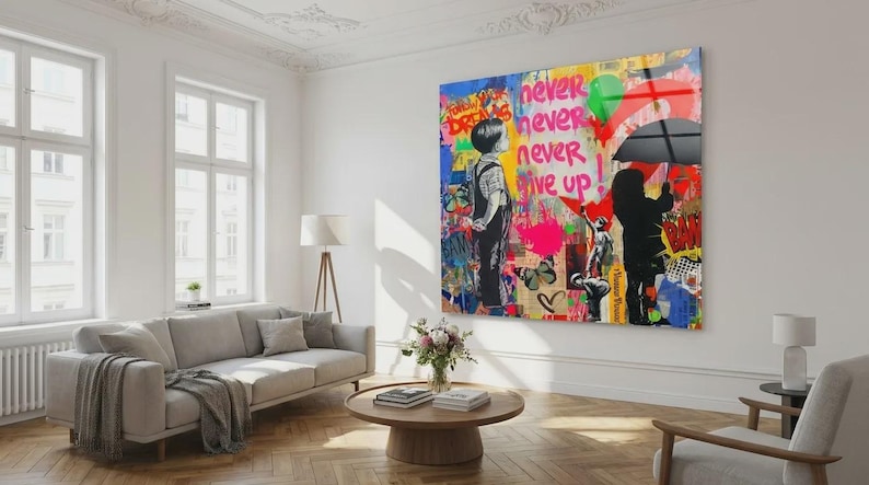May include: A large, colorful wall art piece with the words "never never never give up" in pink and white. The artwork features two figures, one with an umbrella, and graffiti-style elements.