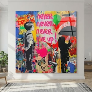 May include: A large, colorful wall art piece with the words "Follow Your Dreams" and "Never Never Give Up." The artwork features a boy and a girl, graffiti, and a heart. The piece is displayed in a bright, modern room.
