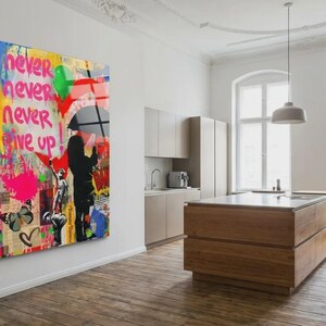 May include: A large, colorful Banksy-style artwork on a wall. The artwork features a child looking up, a figure with an umbrella, and the words "Follow Your Dreams" and "Never Give Up." The background is a mix of colors.