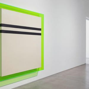 May include: Abstract wall art featuring a cream-colored rectangular panel with two horizontal black stripes, encased in a vibrant neon green frame. The artwork is mounted on a white wall in a modern gallery setting.