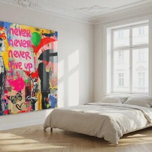May include: A large, colorful Banksy-style artwork dominates a bright room. The artwork features a child figure, butterflies, and the words "Follow Your Dreams" and "Never Give Up." The room includes a bed with neutral bedding, windows, and potted plants.