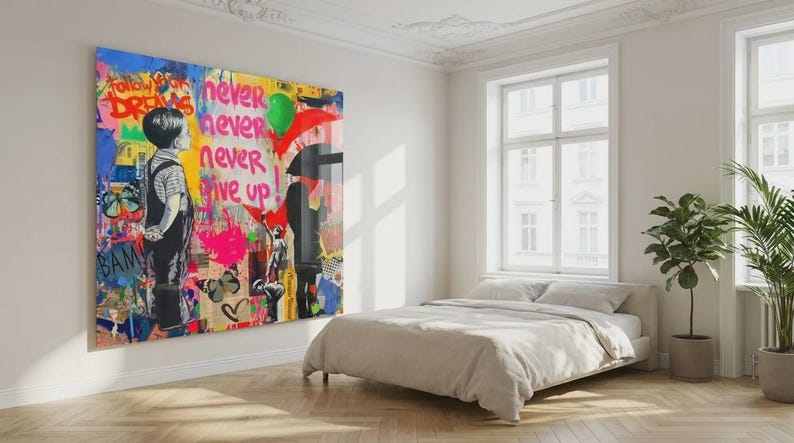 May include: A large, colorful Banksy-style artwork dominates a bright room. The artwork features a child figure, butterflies, and the words "Follow Your Dreams" and "Never Give Up." The room includes a bed with neutral bedding, windows, and potted plants.