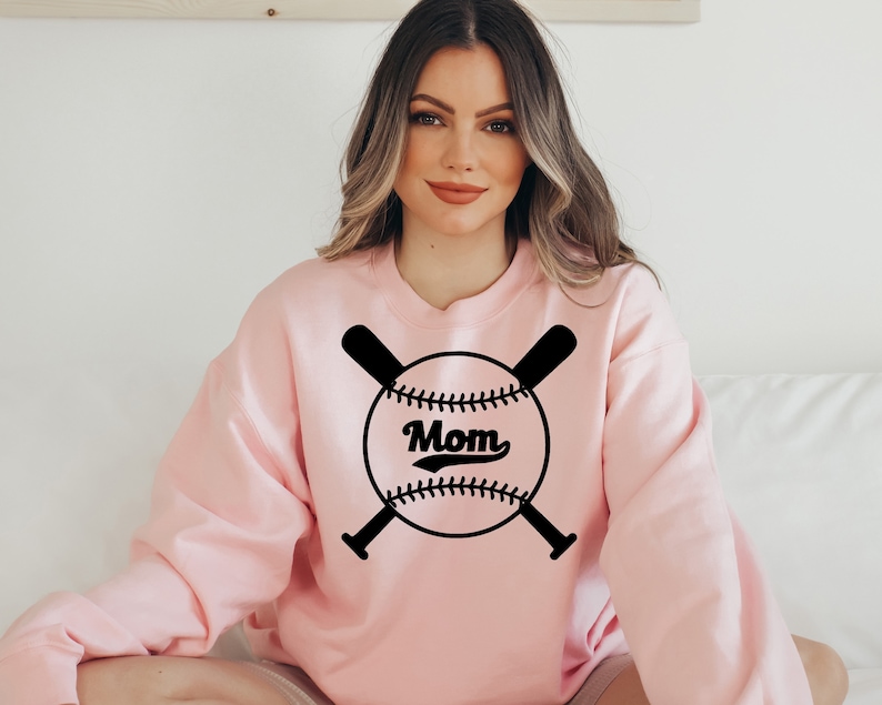 May include: A pink sweatshirt with a black baseball graphic and the word "Mom" in a vintage font.