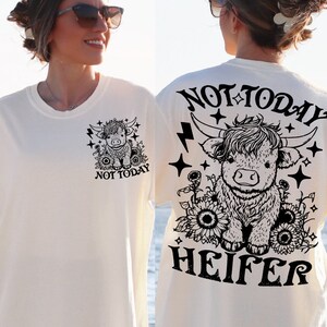May include: White t-shirt with a black and white illustration of a Highland cow with the text "Not Today Heifer" on the back.