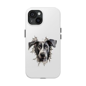 May include: White iPhone case with a black and white dog peeking through a hole in the case. The dog's head is visible, with its ears sticking out of the hole.