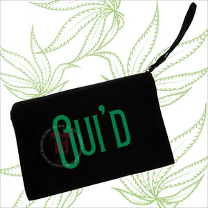 May include: Black clutch with a wrist strap, featuring the word "GUID'D" in green lettering. The clutch has a zipper closure and a small logo. The background has a pattern of green cannabis leaves.