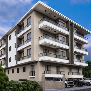 Puede incluir: Un edificio de apartamentos de varios pisos con un diseño moderno. El edificio presenta una fachada gris claro con balcones blancos y barandillas negras. Las ventanas están espaciadas uniformemente y hay coches aparcados delante. El cielo es azul con nubes.