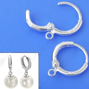May include: Two silver-toned earring hoops with a hinged clasp. Each hoop has a small loop at the bottom for attaching a pendant. The hoops are shown with white pearl pendants attached.
