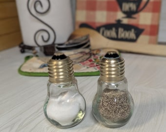 Salt and Pepper Shaker: Clear Glass Light Bulb Shaped Salt and Pepper Shakers