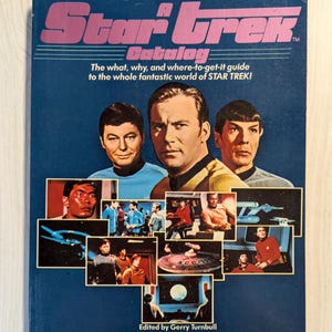 May include: A vintage Star Trek catalog with a blue cover featuring images of the main characters and scenes from the series. The title "Star Trek Catalog" is in pink and white. The text reads "The what, why, and where-to-get-it guide to the whole fantastic world of STAR TREK!"