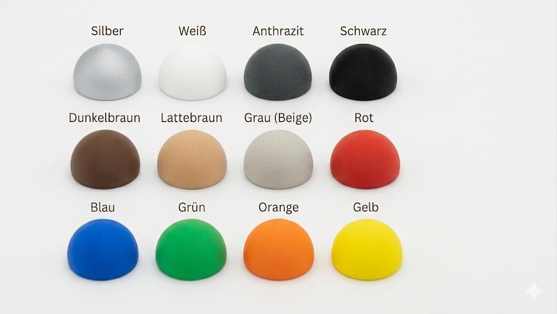 May include: A grid of twelve hemispherical objects arranged in three rows and four columns. The colors include silver, white, charcoal, black, dark brown, light brown, beige-gray, red, blue, green, orange, and yellow, each labeled with text.