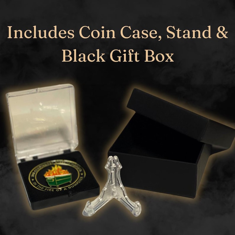 May include: A clear plastic coin case with a black lid, a clear plastic stand, and a black gift box. The coin case contains a gold-colored coin with a green trash can and flames on it. The coin has the text "IN THE FIRE OF A QUIAPSTER" around the edge.