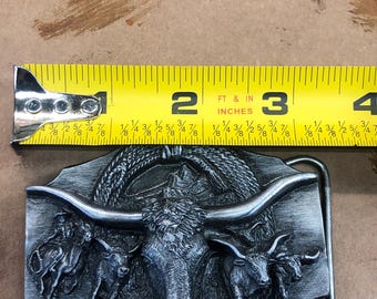 Belt buckle of long horn steer and cowboy Siskiyou buckle company USA