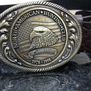 leather belt with metal buckle with eagle on it and North American hunting club up cycled reconditioned belt added buckle western design