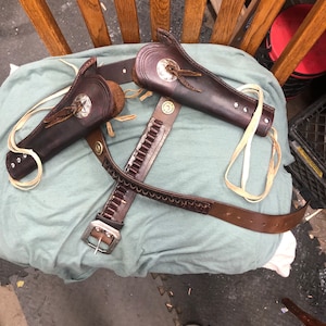 holsters vintage leather up cycled holsters and belt cleaned Re-dyed all added rivets and shell holders fits 22 revolvers and shells