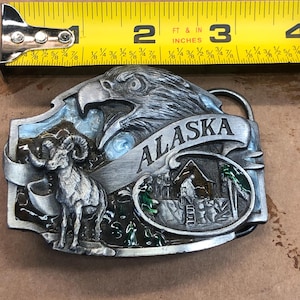 belt buckle Alaska scene of Eagle ,big horn sheep and miners cabin sisikiyou      buckle company USA