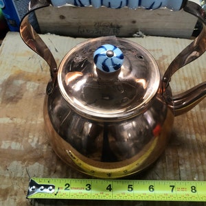 Copper tea pot with porcelain handles
