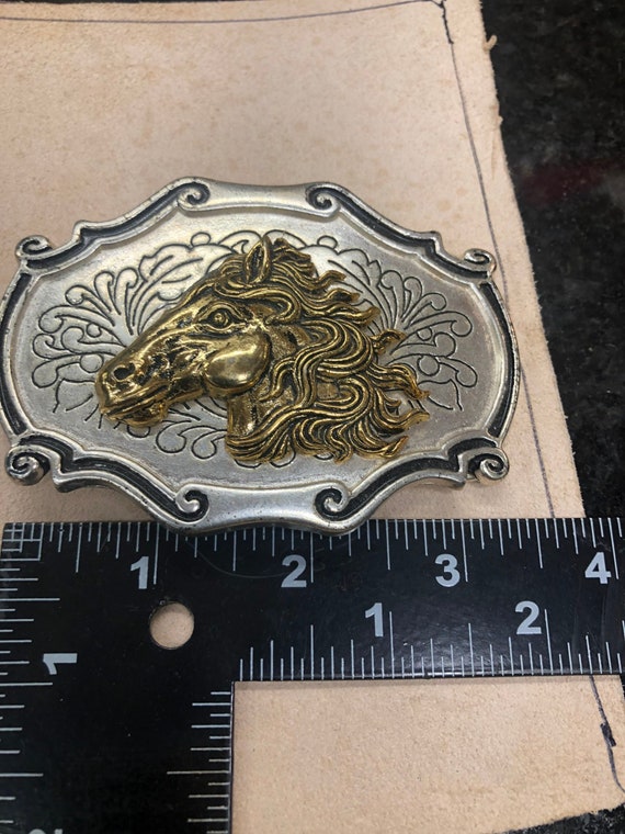 Silver and gold belt buckle horse head