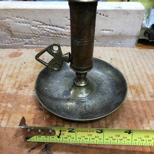 Brass candle holder with adjustable handle and remover slider