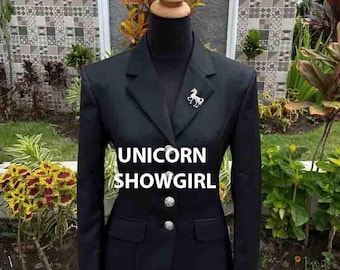 May include: A black blazer with a silver unicorn pin and two silver buttons. The blazer has a classic design with a notched lapel and two front pockets. The text "UNICORN SHOWGIRL" is displayed on the front.