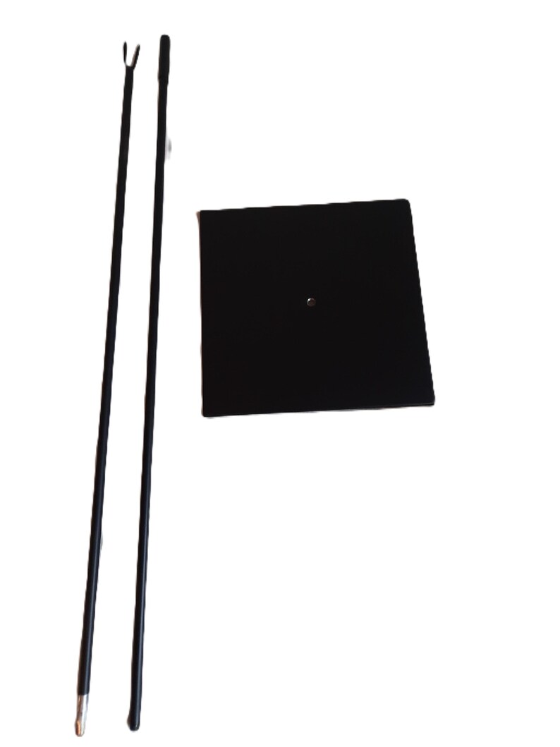 May include: Two black metal poles with a black square base. The poles are telescoping and can be adjusted to different heights. The base has a small hole in the center.