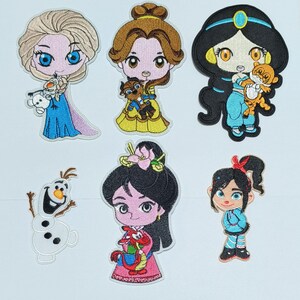 May include: Set of ten embroidered iron-on patches featuring Disney characters. The characters include Elsa, Belle, Jasmine, Mulan, Olaf, and Rapunzel. The patches are colorful and detailed.
