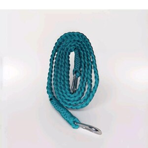 May include: A teal blue braided rope dog lead with a silver metal clip.