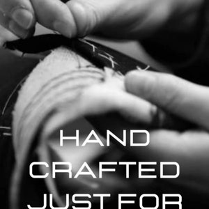 May include: Black and white image of hands sewing fabric. The text "HAND CRAFTED JUST FOR YOU" is displayed in white, bold letters. The image highlights the craftsmanship and personalized nature of the product.