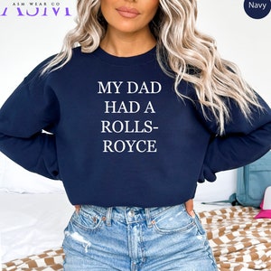 May include: A navy blue sweatshirt with the text "My Dad Had A Rolls-Royce" printed in white.