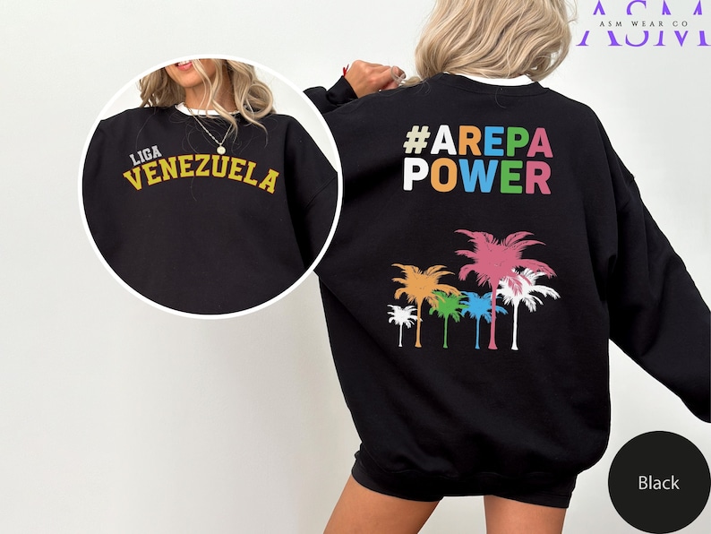 May include: Black sweatshirt with a colorful palm tree graphic and the text "#AREPA POWER" on the back. The front of the sweatshirt has the text "LIGA VENEZUELA" in yellow.