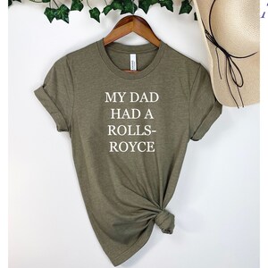 May include: A green t-shirt with the text "My Dad Had A Rolls-Royce" printed in white.