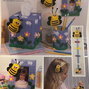 May include: An assortment of handmade bee-themed crafts, including a tissue box cover, pencil holder, picture frames, and hair accessories. The items are decorated with yellow and black bees, flowers, and the text "ABUZZ WITH BEES".