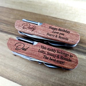 May include: Two wooden multi-tools with stainless steel tools. One is engraved with "Daddy" and "Happy Birthday Love you Harry & Ronnie." The other says "Dad" and "This daddy belongs to Lotty, Sonny & Bonnie. The best ever!"