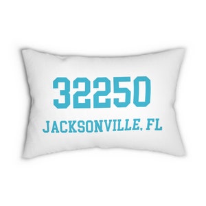 May include: White rectangular pillow with the teal text "32250 JACKSONVILLE, FL". The pillow is a soft, plush material. The text is in a bold, sans-serif font.