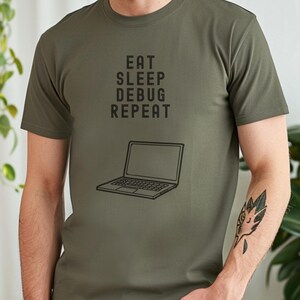 May include: A green t-shirt with the text "Eat Sleep Debug Repeat" and a laptop graphic.