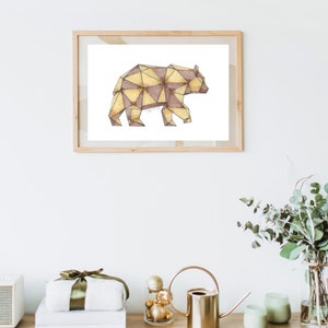 May include: A framed print of a geometric bear illustration. The bear is made up of triangles in shades of brown and gold.