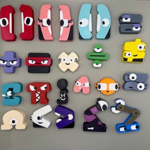 May include: A collection of colorful, cartoon-like magnets with various shapes and expressions. The magnets feature characters with different facial expressions, including happy, sad, angry, and surprised. The magnets are made of a durable material and are perfect for adding a touch of fun to any refrigerator or magnetic surface.