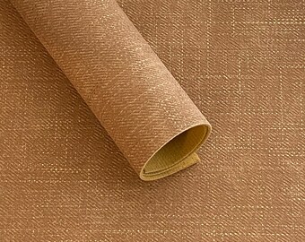 May include: A close-up of a brown fabric with a subtle woven texture. The fabric is rolled up, showing the underside of the material.