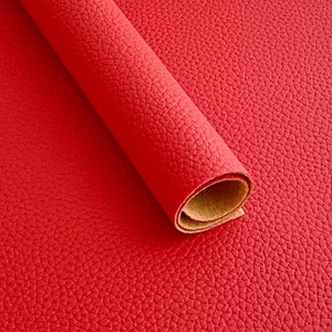 May include: A roll of red faux leather with a textured surface.