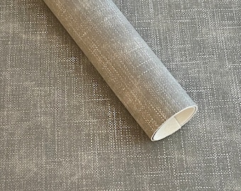 May include: A roll of gray textured fabric with a subtle white pattern. The fabric has a linen-like appearance.