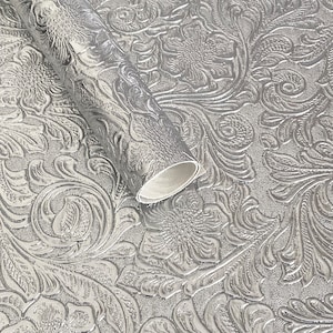 May include: Silver metallic wrapping paper with an embossed floral pattern.