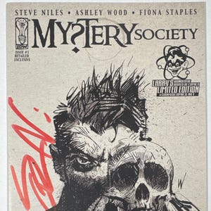 May include: A comic book cover for "Mystery Society" featuring a black and white illustration of a man holding a skull. The cover includes the title, issue number, and the names of the authors. The cover has red graffiti-style accents and a "Limited Edition" logo.