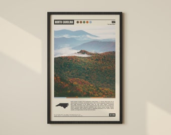 May include: A vintage-style poster featuring a photograph of a misty mountain range in North Carolina. The poster is framed in black and has a colour palette of brown, green, blue, and white. The text on the poster reads "North Carolina" and "USA - The Tar Heel State".