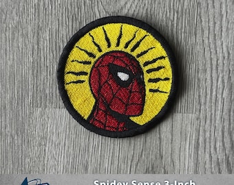 May include: A round, embroidered patch featuring Spider-Man's head in red and black, set against a yellow background with black rays. The patch is 3 inches in diameter and has a black border. Text at the bottom reads "Spidey Sense 3-Inch Iron-on/Sew-On Patch."